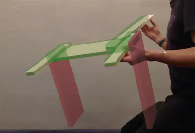 Figure 39: Live overlay during an early assembly step. Completed parts are shown tracked to the object, and the next piece(s) to add appear in translucent red,