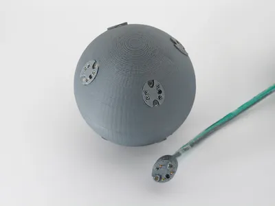 Figure 1.  Each Graphmaster node is a plastic hemisphere with four ports for connecting edges.  Each edge is a length of electroluminescent wire with a connector at each end.