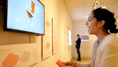 Fig. 7 Interacting with the final press interactor prototype at the CMU School of Architecture thesis exhibition
