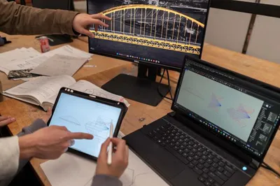 Fig. 2. Students using interactive graphic statics drawings to study the form and force diagrams of local bridges.