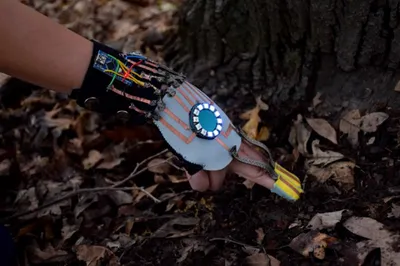 Figure 1: The Hand-Substrate Interface creates a direct 
connection and engagement with environment by requiring 
the wearer to physically insert their hands in soil to obtain a 
digital moisture reading.